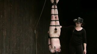 Strapped lesbian in inverted suspension